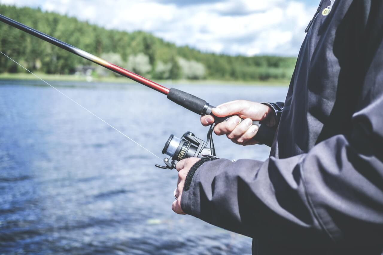 man fishing in lake