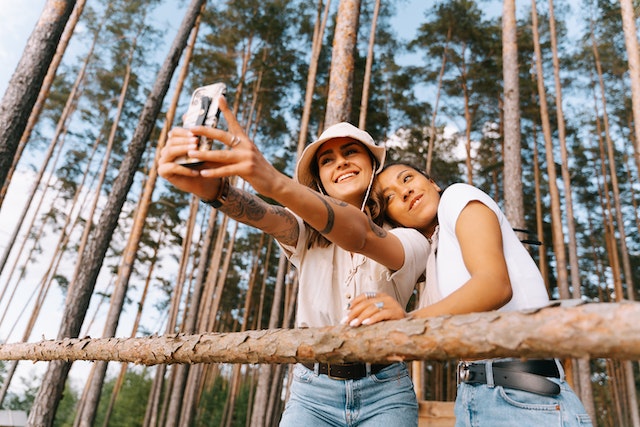 Two women taking a selfie in forest