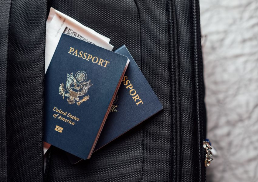 a couple of United States passports pocking out of a luggage’s pocket